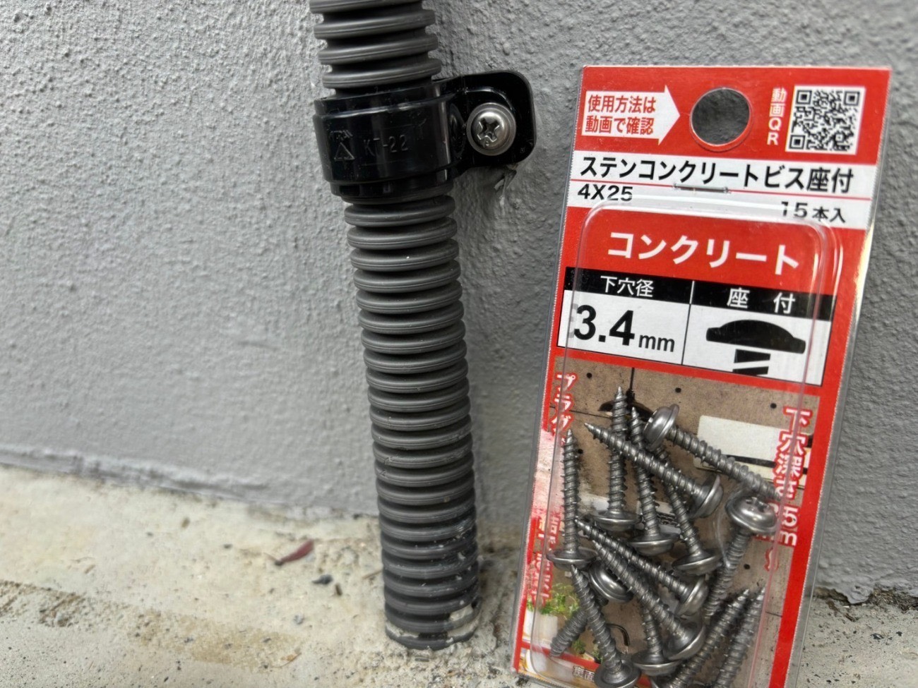 外壁の配線を固定する金具をステンレス製に取り付けた様子