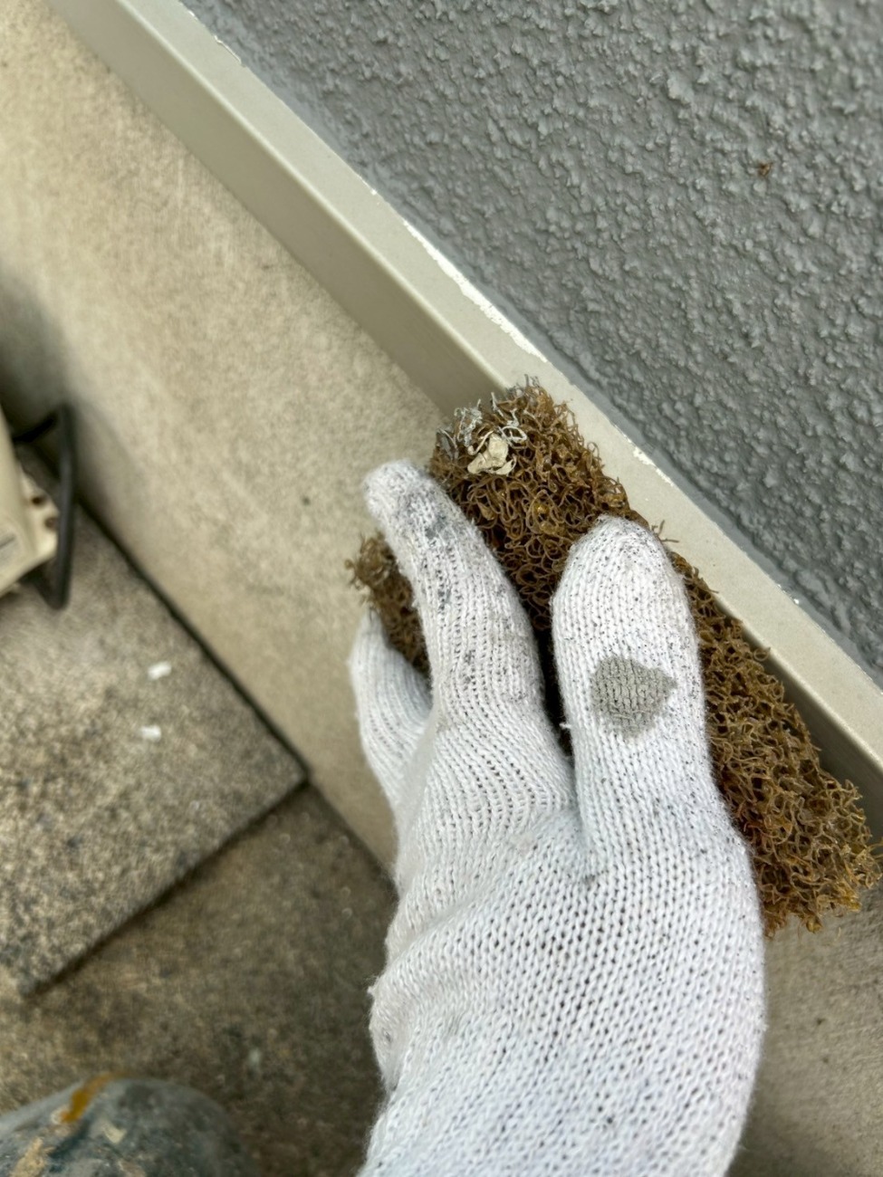 基礎水切り板金の表面をケレンして整えている様子